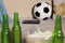 Conceptual watching football game at sofa on television with beer bottles and popcorn bowl in friends enjoying soccer game TV