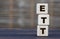 Conceptual word ETT on cubes on a gray blurred background