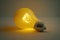 Conceptual yellow lightbulb with a white glow, intended to inspire original thought