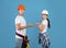 Concerned couple of workers man and woman shrugging over blue background