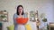 Concerned woman holding a bucket where water flows from the ceiling slow mo