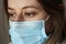 Concerned and worried woman medical worker in protective medical face mask. Doctor protection from Coronavirus, covid-19