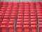 Concert Platform Closeup with Rows of Red Plastic Seats