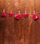 Concert for Valentine`s Day. Red hearts made of felt pinned with clothespins to a string against background of boards