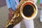 Concert view of saxophonist in a blue and white suit, a saxophone sax player with vocalist and musical band during jazz orchestra