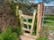 A concertina gate stile between two fields on a country walking route.