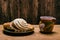 Concha and other sweet breads on wooden table. Typical Mexican desserts.Typical mexican sweet breads and red ceramic mug