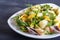 Conchiglie colored pasta with fresh greengrocery on black wooden background