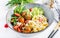 Conchiglie with meatballs, feta cheese and salad on light background.