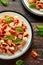 Conchiglie Tuna pasta with tomato sauce, feta cheese and basil on wooden table. healthy food