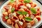 Conchiglie Tuna pasta with tomato sauce, feta cheese and basil on wooden table. healthy food