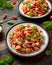 Conchiglie Tuna pasta with tomato sauce, feta cheese and basil on wooden table. healthy food