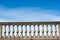 Concrete balustrade on a blue sky with clouds