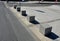 Concrete barriers as protection of a nice lawn cube cubes on a paved sidewalk platform of a tram protected from the entry of cars