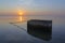 Concrete block in tagus river at sunrise