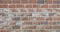 Concrete block wall. Every Brick has three shades of colors: red, gray and white.