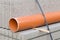 Concrete blocks and plastic pvc sewage pipe on palette on construction site