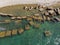 Concrete blocks and tetrapods on the seashore as seashore protection. Top aerial view made by drone