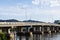 The concrete bridge across the Khwae river with blue sky, Kanchanaburi province, Thailand