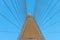 Concrete bridge pylon with parallel lines of steel cable.