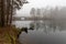 Concrete bridge serving as a crossing over the lake. Fog rising over the lake