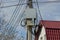 Concrete column with a black cable and electric wires and an iron gray box