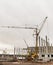 Concrete construction yard building site crane cloudy sky background