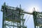 Concrete counterweights on truss towers of a metal drawbridge in sunlight