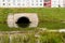 Concrete culvert pipe hole system draining sewage water near the