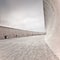 Concrete or dam structure, wall and floor, cloudy sky.