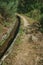 Concrete drainage canal next to dirt path