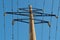 Concrete electric pole with diamond-shaped frames construction with clusters of insulators, to which main high-voltage wires