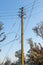Concrete electrical three phase pole with messy wires