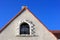 Concrete facade with window in roof attic