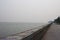 Concrete, fence on the pier embankment sea separates the water from the shore on the horizon