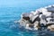 Concrete figure blocks thrown into the sea. Quay of Athens, Greece