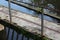 Concrete footbridge with rusty iron railing