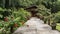 A concrete footpath leads directly to the wooden cottage.