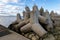 Concrete fortifications in the seaport. Tetrapods stacked on the edge of a breakwater in Central Europe