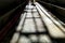 Concrete ground with a shadow of metallic stairs and a man coming forward