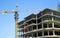 Concrete Highrise Construction site, with Tower Crane, blue sky