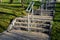 Concrete long staircase with long and short pieces of stairs and ramps made of cobblestone granite paving blocks. packing short ga