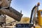 Concrete mixer truck delivers concrete to the pump for pouring piles. Concrete pump at the construction site. Close-up of concrete