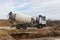 Concrete mixer truck loads concrete at the factory. Transportation of concrete to the construction site. Construction equipment fo