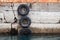 Concrete mooring wall with old used tires