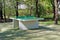 Concrete new green ping pong table set in city public park