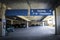 Concrete parking garage with signs saying seven foot clearance with cars parked and emergency box - Selective focus and room for