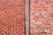 Concrete partition border and line of two old dirty reddish brown worn weathered brick walls texture background