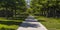 Concrete path amid lawn lined with trees in Utah