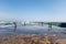 Concrete pier covered with oncoming wave. Eye - bolts. Summer sunny day at sea